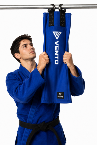 VENTO royal blue BJJ Gi sleeve grip trainer hanging on pull up bar for Jiu-Jitsu grip strength training